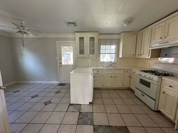 a kitchen with a sink cabinets and window