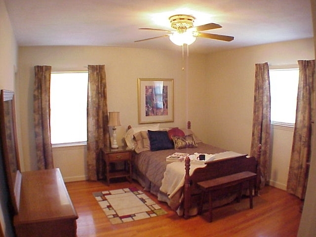 4521 Rosecrest Road Roanoke, VA 24018 - Photo 12 of 27 a bedroom with a bed and a chandelier
