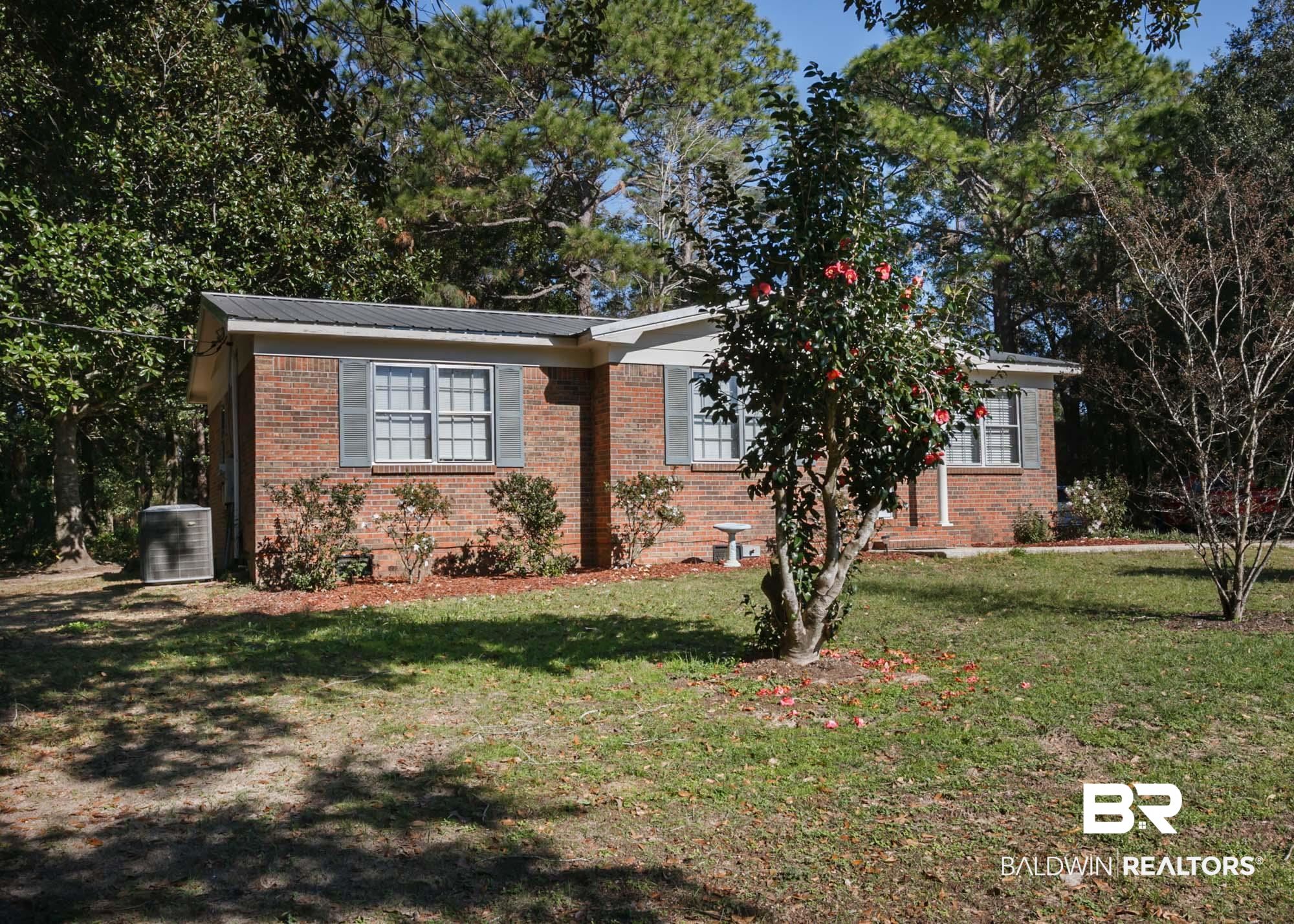 18753 County Road 12 Foley, AL 36535 - Photo 2 of 39 View of front facade with a front yard and central AC unit