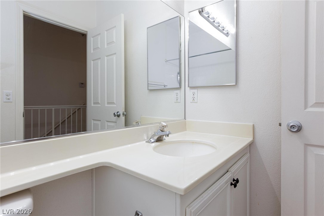 2246 Ramsgate Drive Henderson, NV 89074 - Photo 23 of 36 A pristine bathroom vanity, with a clean counter and bright mirrors, offers functional elegance.
