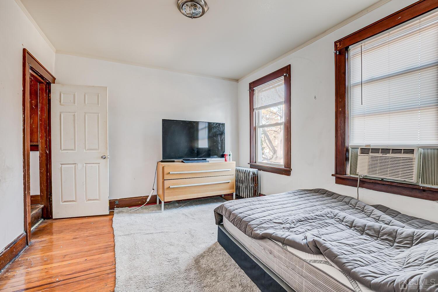 32 Prosper Street New Brunswick, NJ 08901 - Photo 15 of 30 a bedroom with a balcony a bed and a television