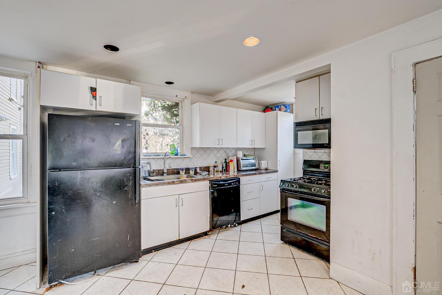 32 Prosper Street New Brunswick, NJ 08901 - Photo 25 of 30 a kitchen with stainless steel appliances granite countertop a refrigerator and a stove
