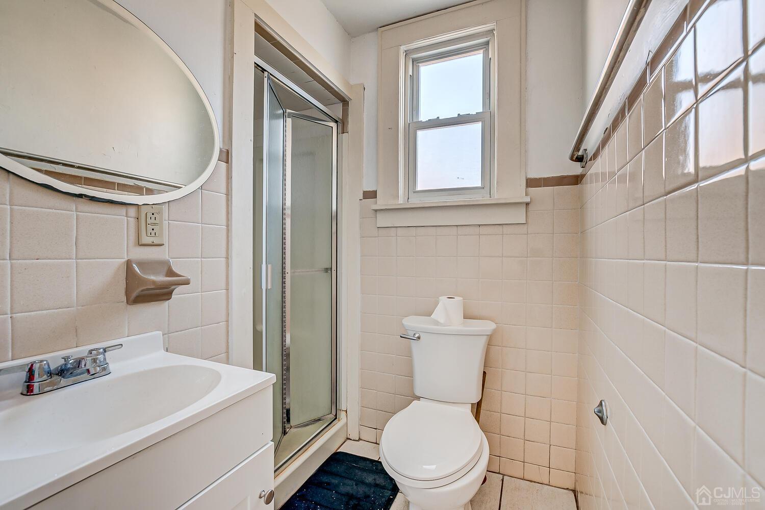 32 Prosper Street New Brunswick, NJ 08901 - Photo 27 of 30 a white toilet sitting next to a bathroom sink