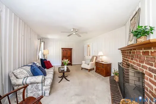 a view of a workspace with furniture and wooden floor