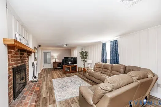 a room with pool table and two windows