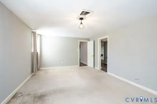a view of an empty room and wooden floor