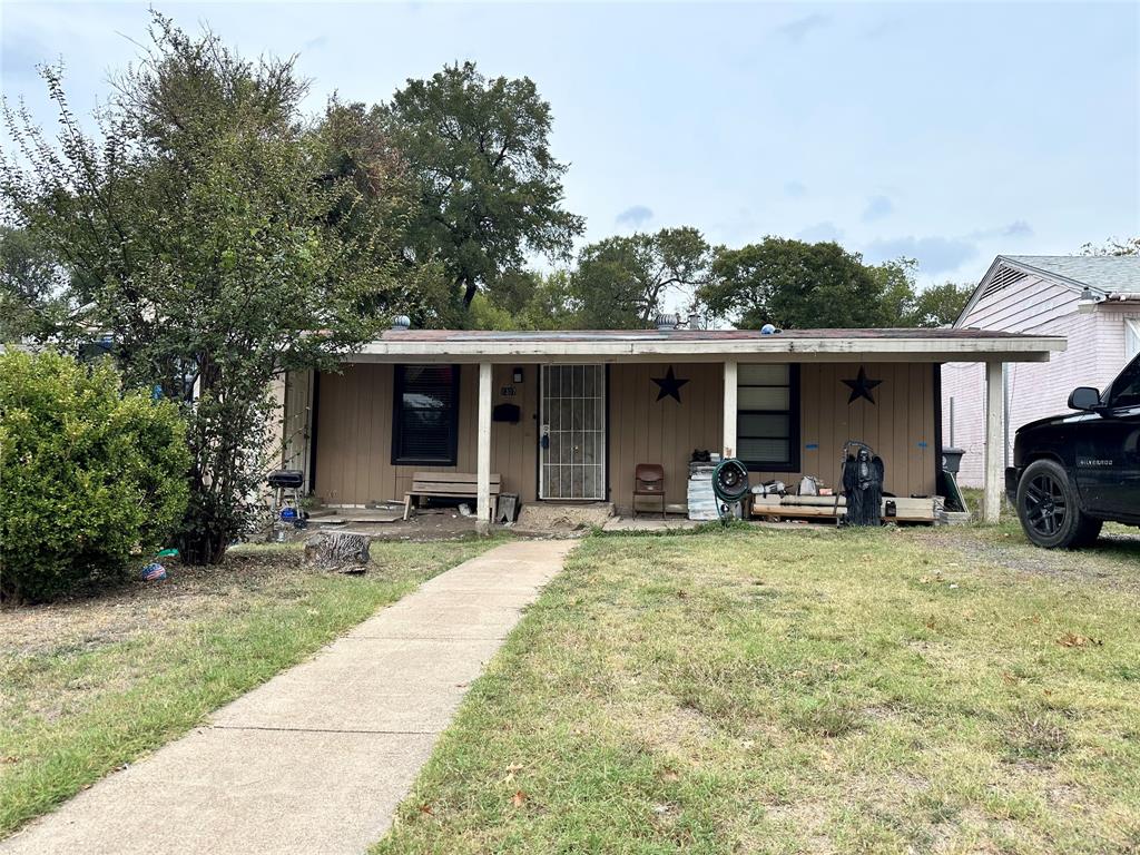 a view of a house with a patio and a yard