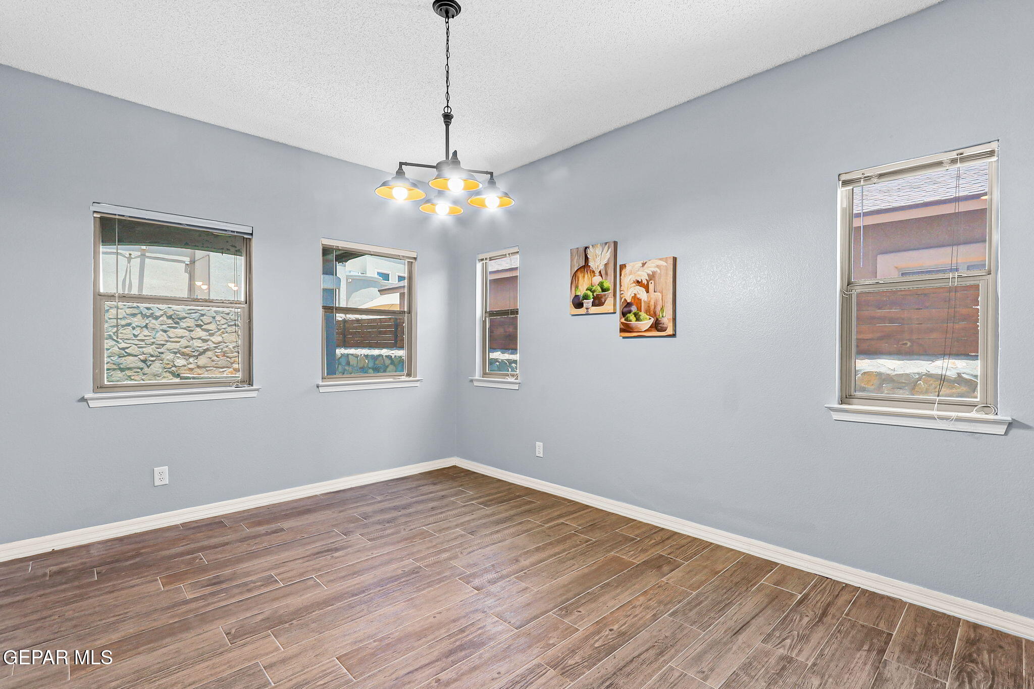 14045 Tower Point Way El Paso, TX 79938 - Photo 12 of 46 a view of livingroom with window ceiling fan and hardwood floor