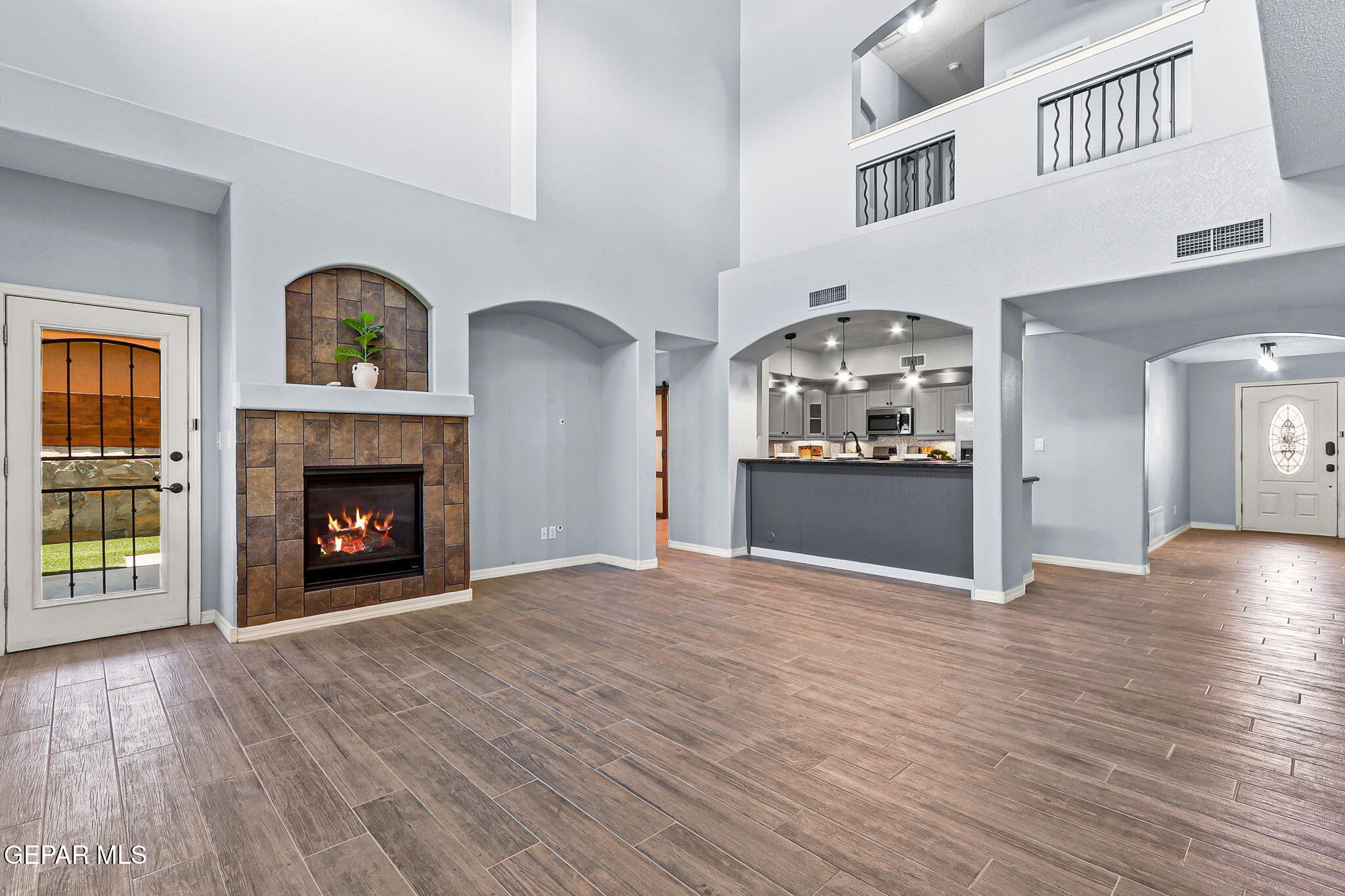 14045 Tower Point Way El Paso, TX 79938 - Photo 17 of 46 a view of a livingroom with a fireplace and wooden floor
