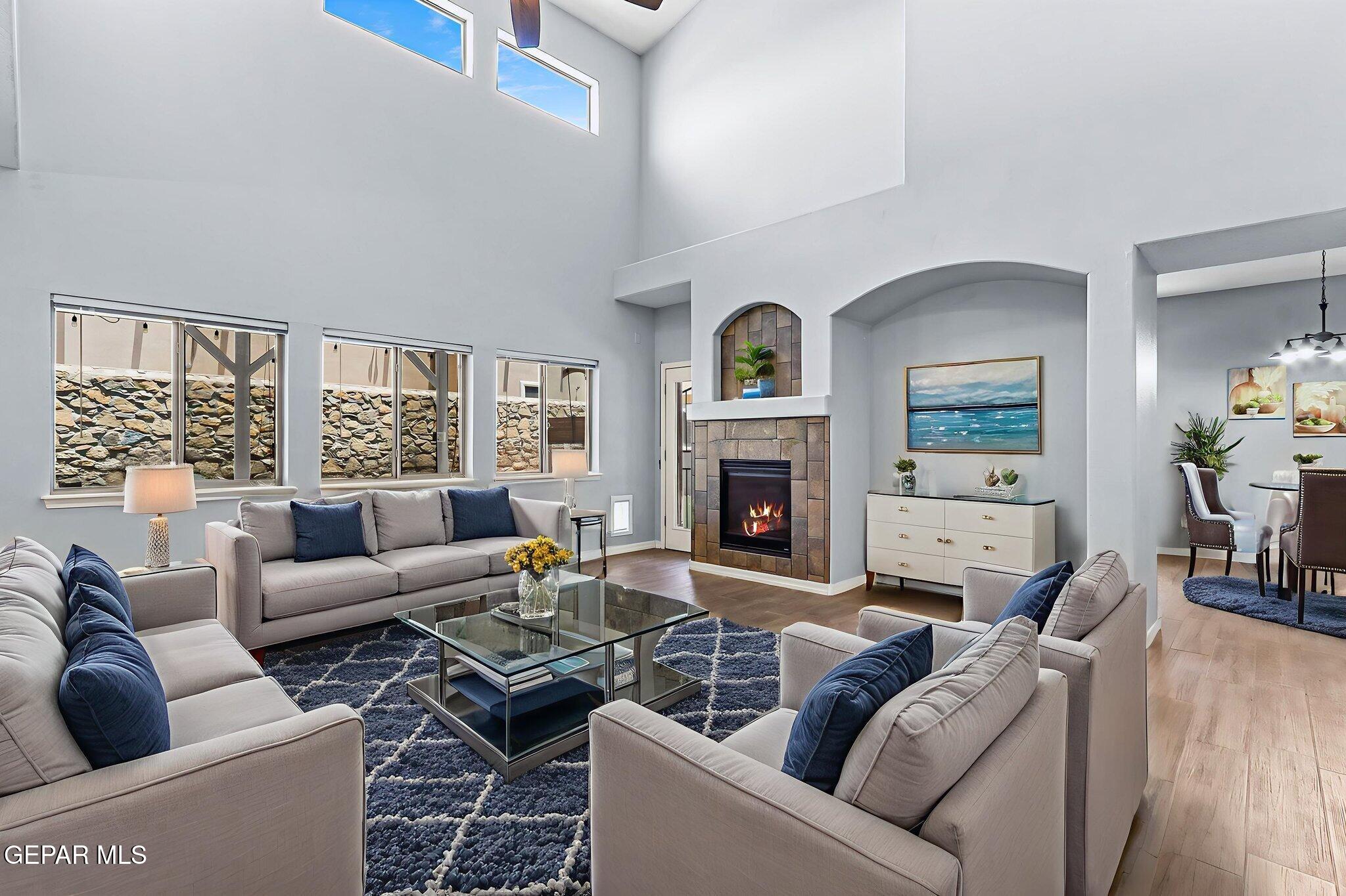 14045 Tower Point Way El Paso, TX 79938 - Photo 18 of 46 a living room with furniture a fireplace and a large window