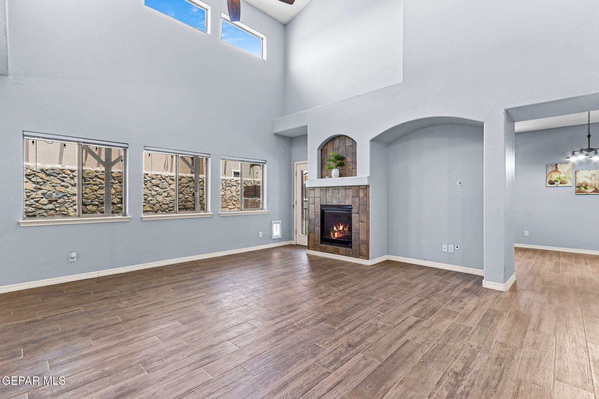 14045 Tower Point Way El Paso, TX 79938 - Photo 19 of 46 wooden floor fireplace and windows in an empty room