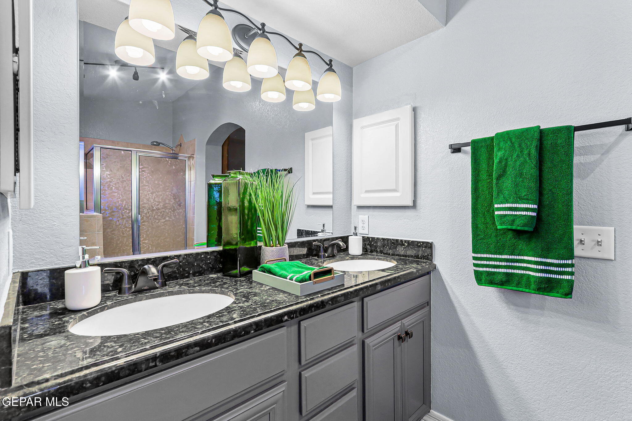 14045 Tower Point Way El Paso, TX 79938 - Photo 28 of 46 a bathroom with a granite countertop sink and a mirror