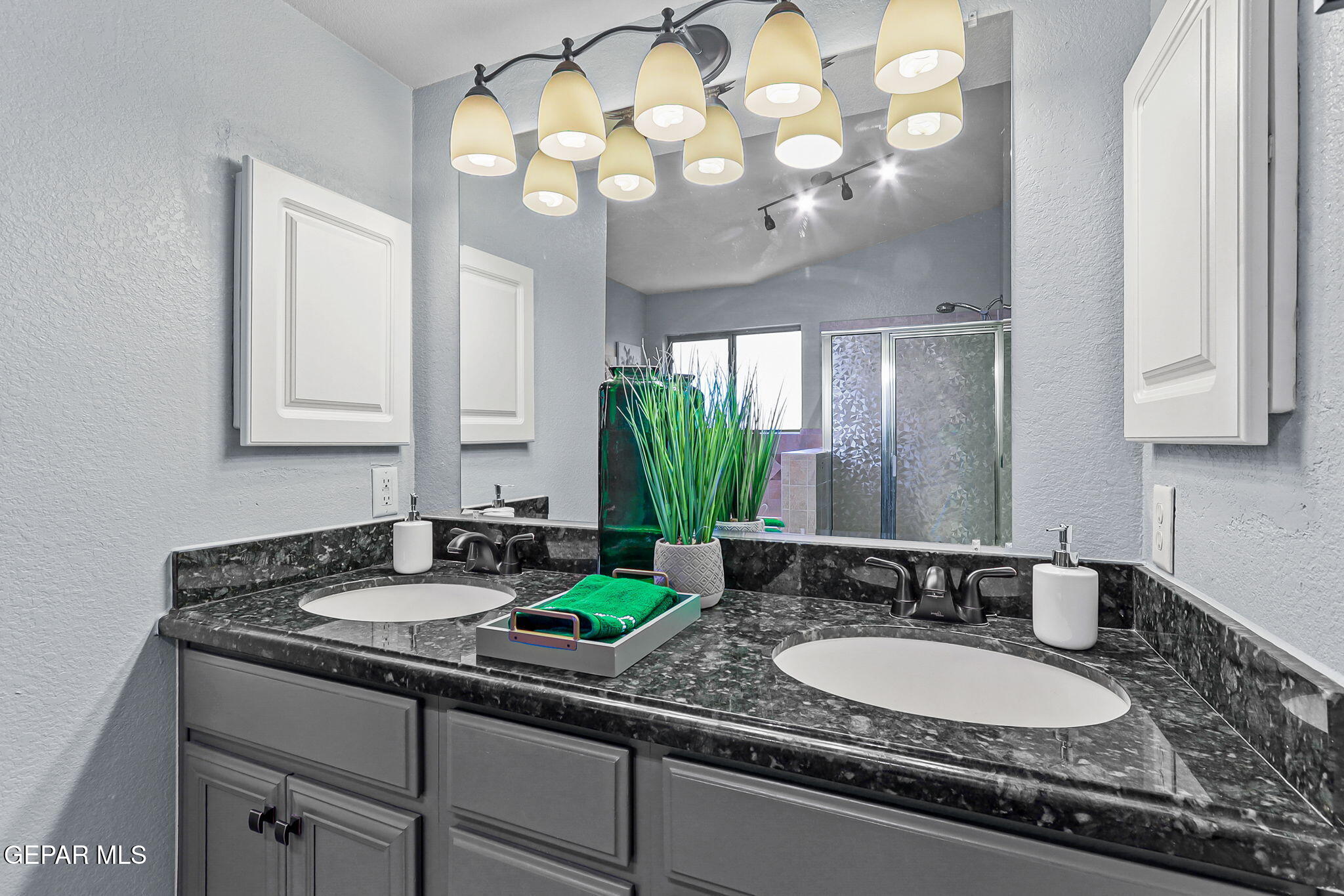 14045 Tower Point Way El Paso, TX 79938 - Photo 29 of 46 a bathroom with a granite countertop double vanity and a mirror