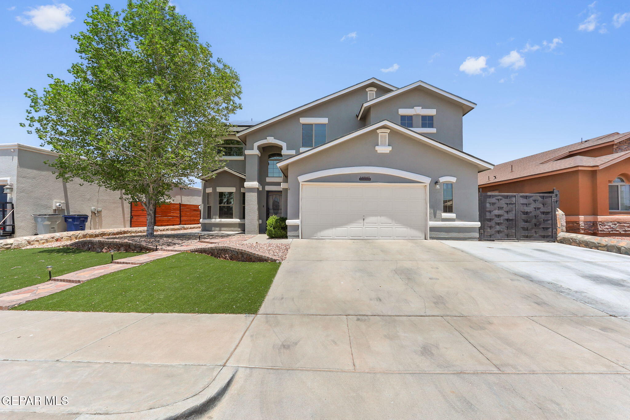 14045 Tower Point Way El Paso, TX 79938 - Photo 3 of 46 a front view of a house with a yard
