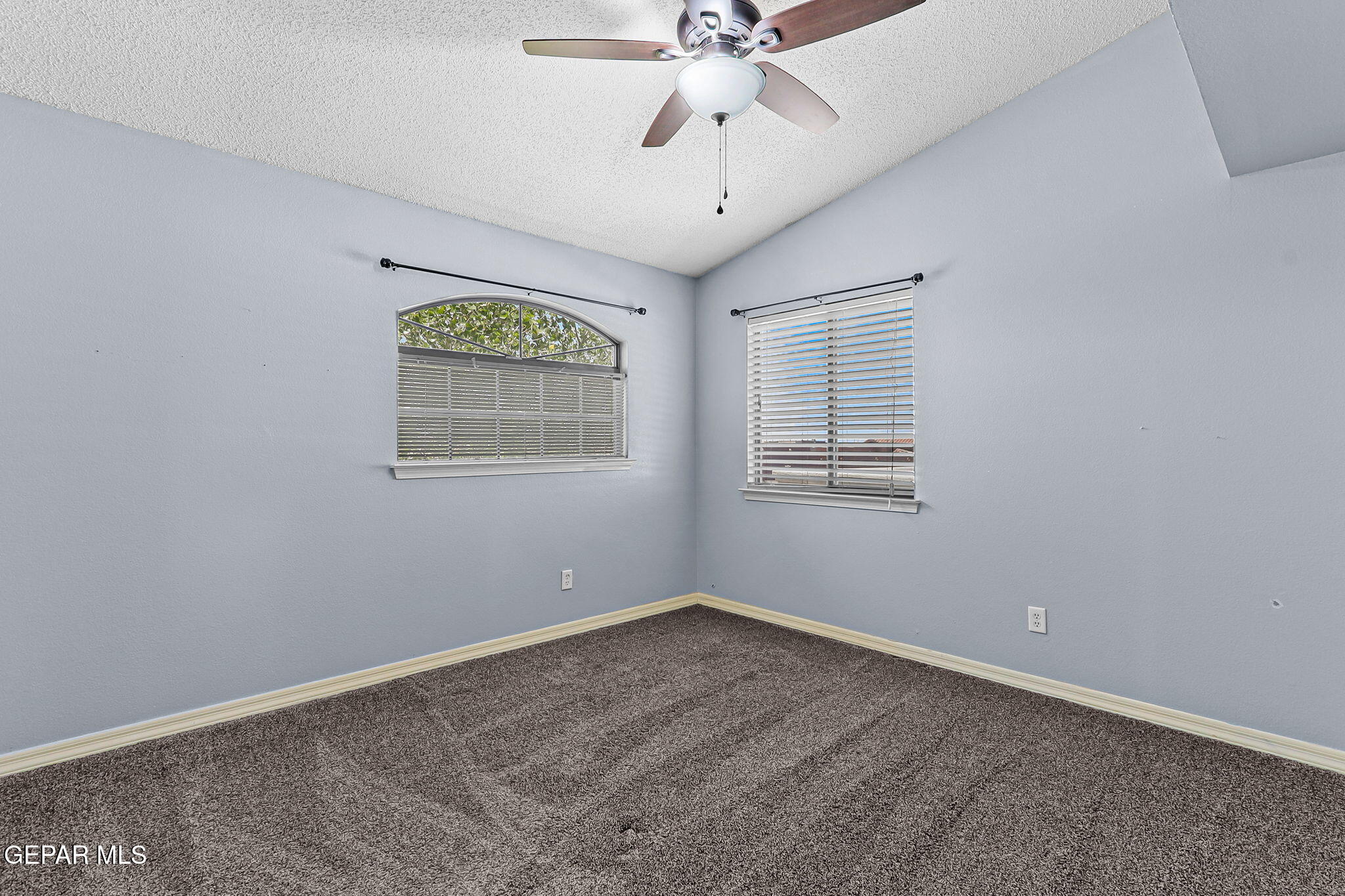 14045 Tower Point Way El Paso, TX 79938 - Photo 36 of 46 an empty room with a window and a chandelier fan