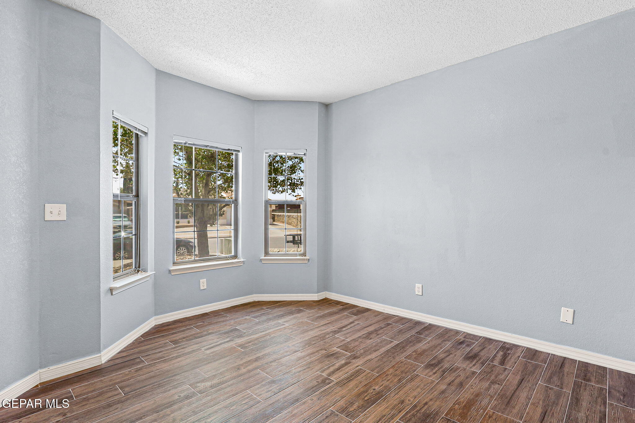 14045 Tower Point Way El Paso, TX 79938 - Photo 6 of 46 an empty room with wooden floor and windows