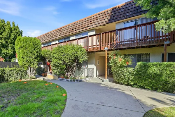 a path view of a house with wooden fence