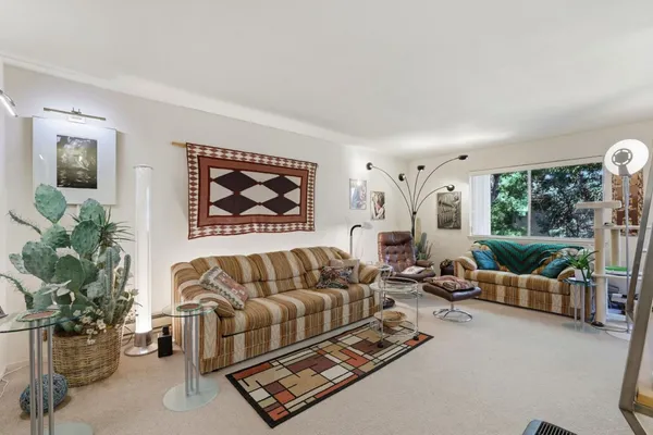 a dining room with furniture water view and a floor to ceiling window