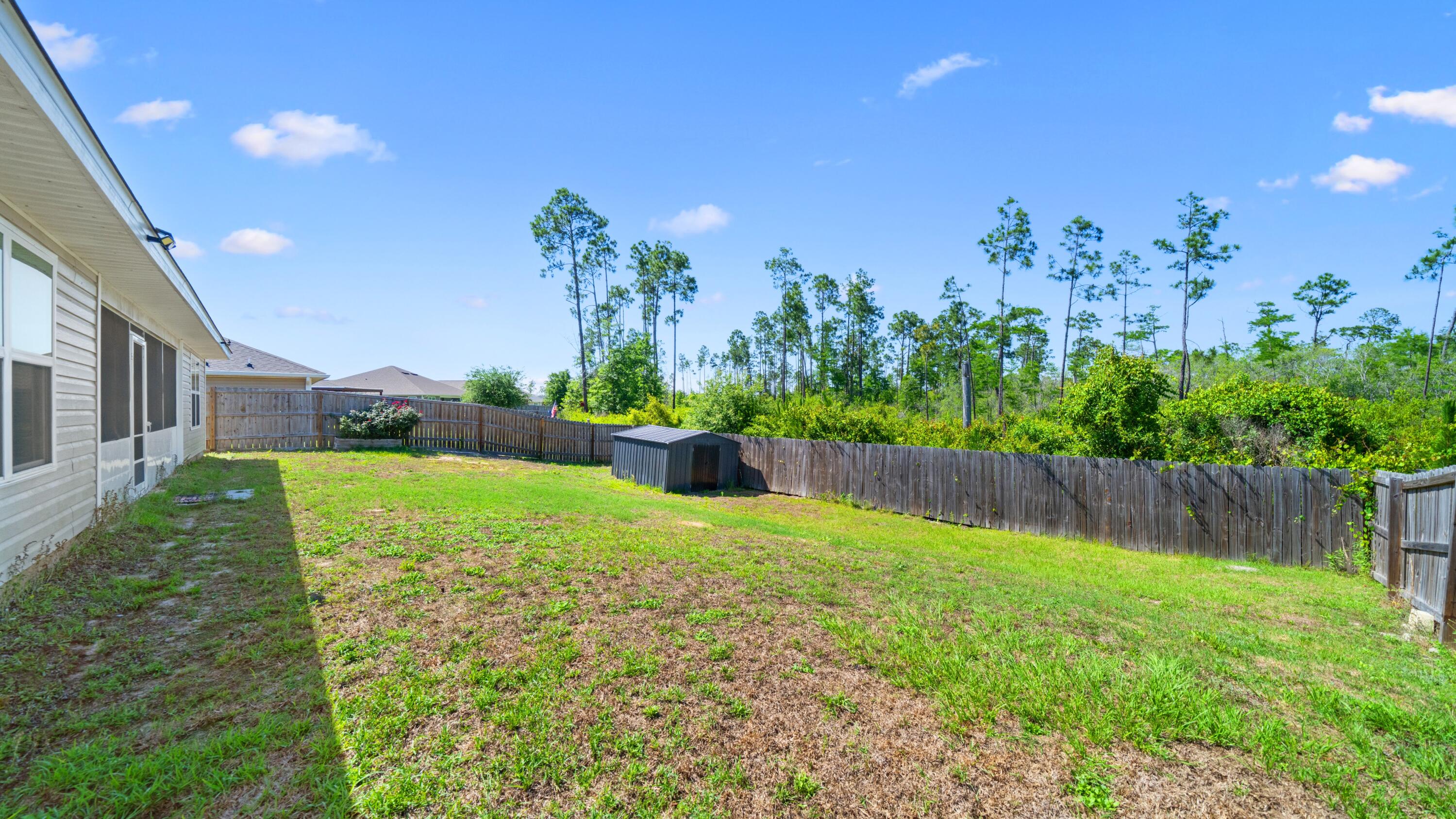 3927 Alva Thomas Road Panama City, FL 32404 - Photo 33 of 46 a view of backyard with swimming pool and outdoor seating