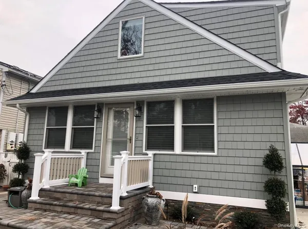 a front view of a house with large windows