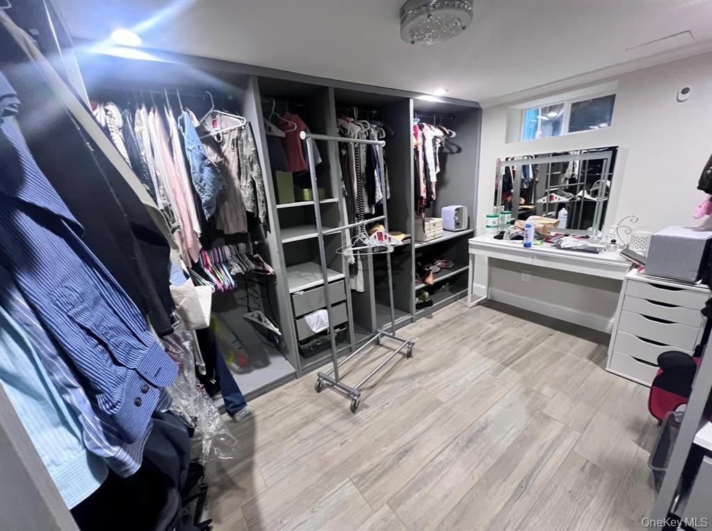 286 Beachview Street, Unit B Copiague, NY 11726 - Photo 7 of 9 a view of walk in closet with clothes and shoes