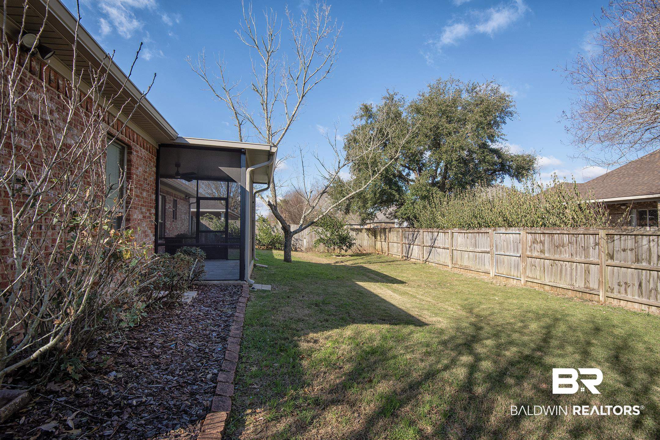 9421 Collier Loop Daphne, AL 36526 - Photo 30 of 31 Fenced backyard with a sunroom
