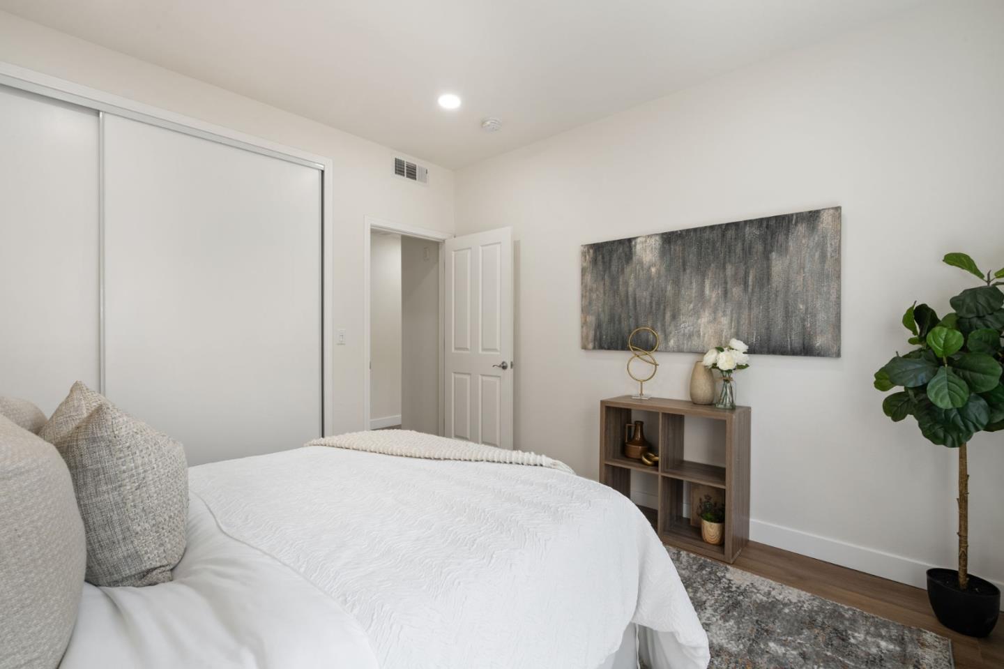 729 Cottage Court Mountain View, CA 94043 - Photo 17 of 41 a bedroom with a bed and a potted plant