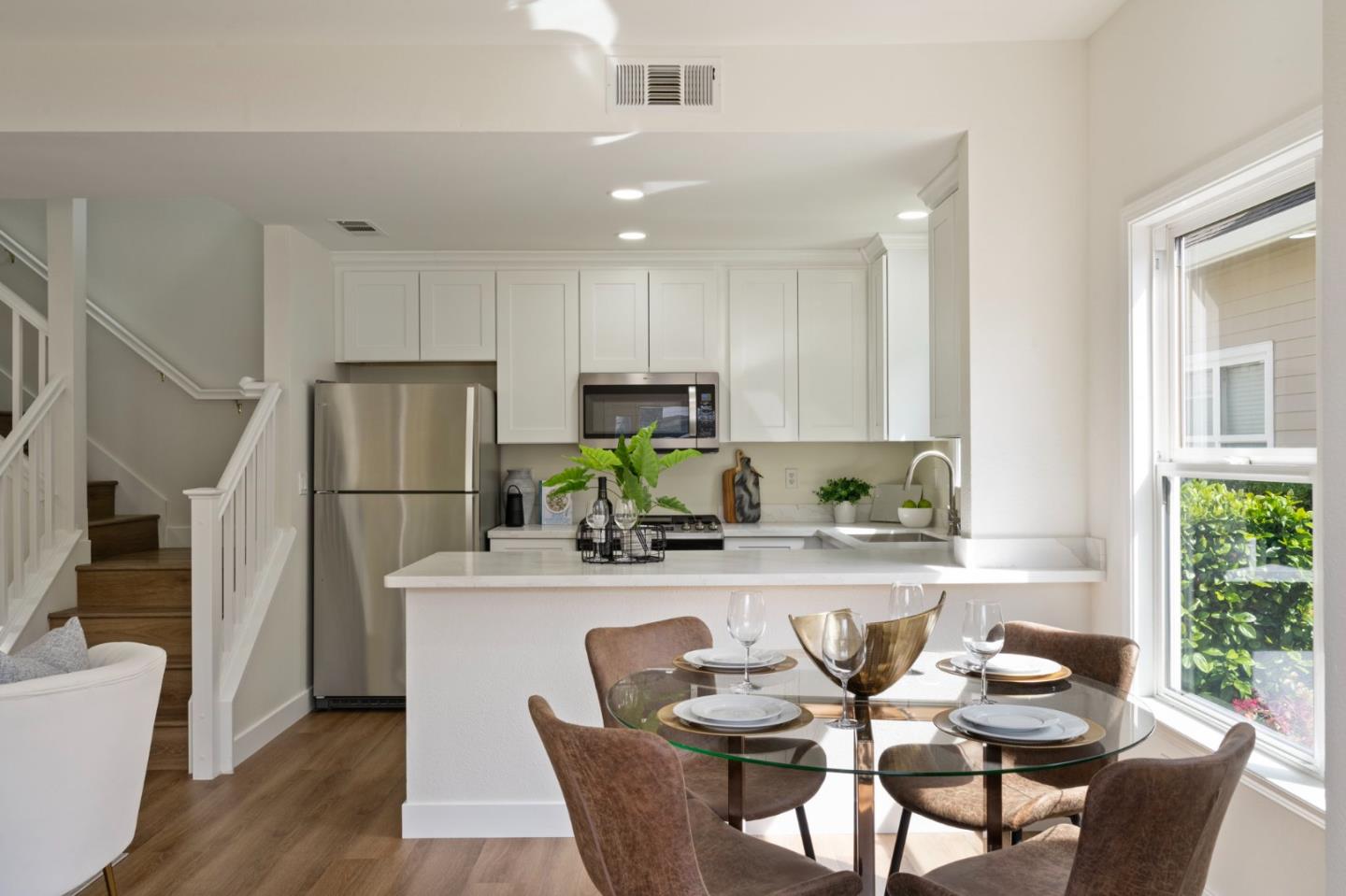 729 Cottage Court Mountain View, CA 94043 - Photo 3 of 41 a kitchen with stainless steel appliances kitchen island granite countertop a refrigerator a stove a sink dishwasher and a dining table with wooden floor