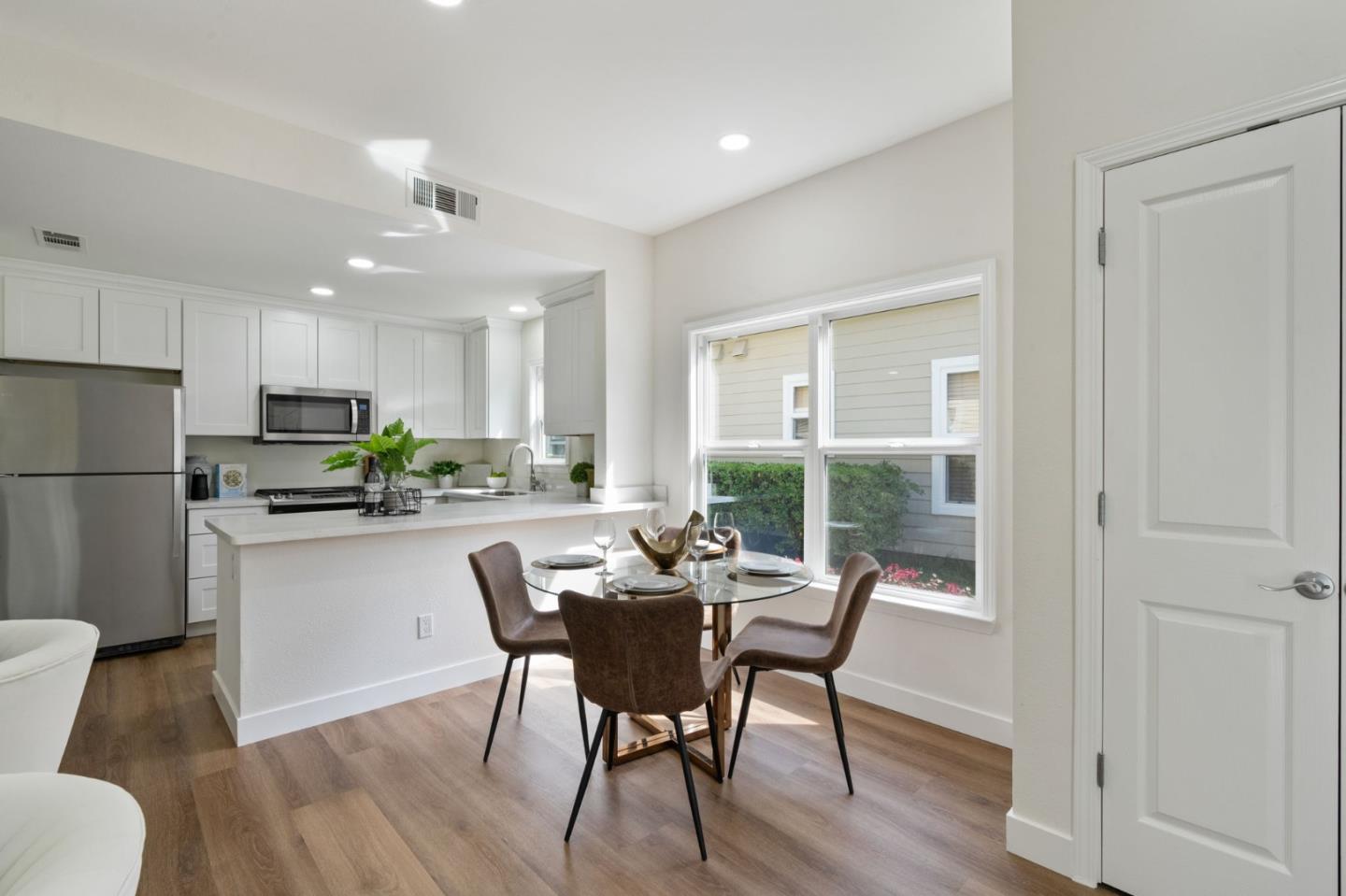 729 Cottage Court Mountain View, CA 94043 - Photo 4 of 41 a kitchen with kitchen island a dining table chairs stainless steel appliances and cabinets