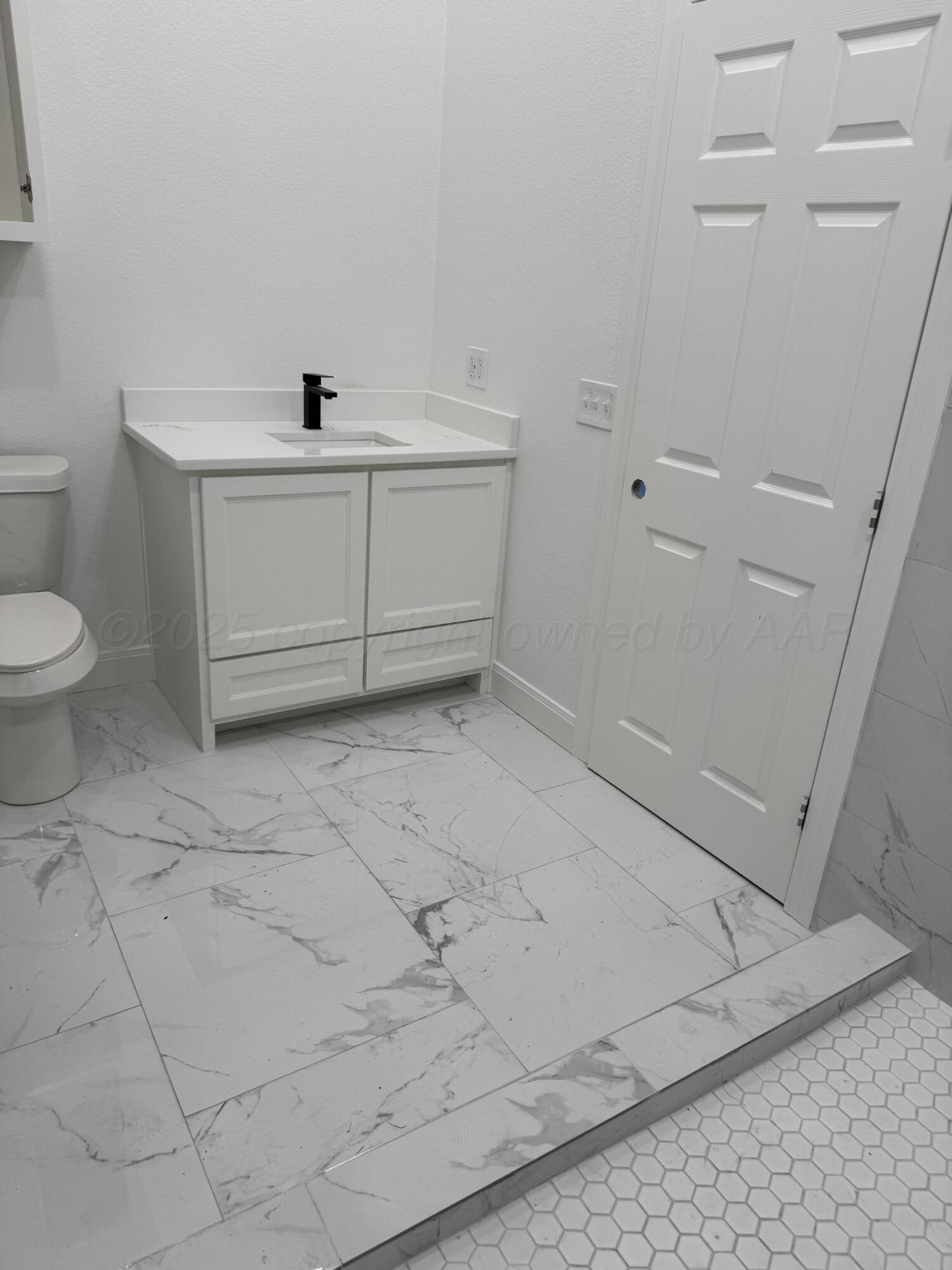 3602 South Hayden Street Amarillo, TX 79110 - Photo 3 of 8 a bathroom with a sink toilet and vanity