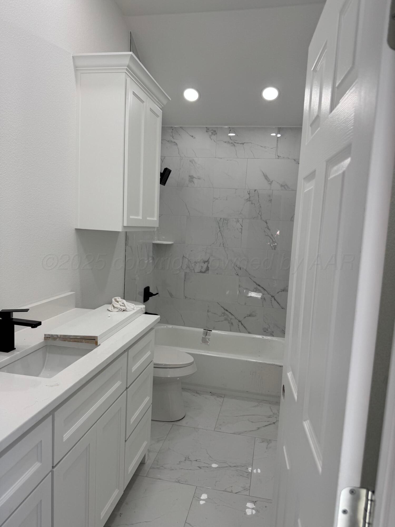 3602 South Hayden Street Amarillo, TX 79110 - Photo 4 of 8 a bathroom with a granite countertop sink mirror vanity and toilet
