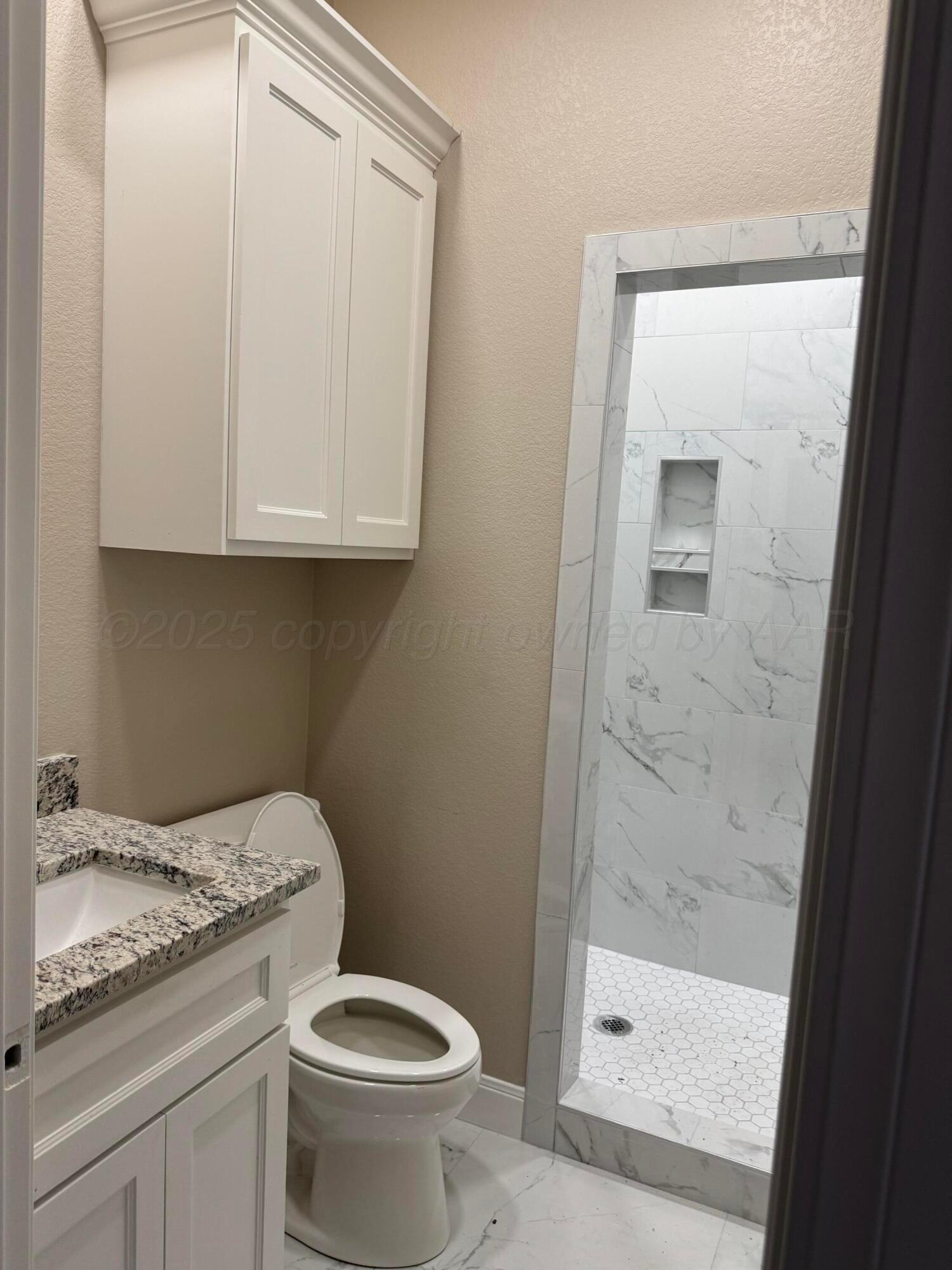 3602 South Hayden Street Amarillo, TX 79110 - Photo 6 of 8 a bathroom with a granite countertop toilet and a sink