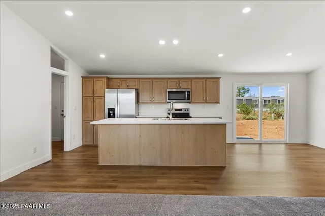 a view of kitchen with microwave and cabinets