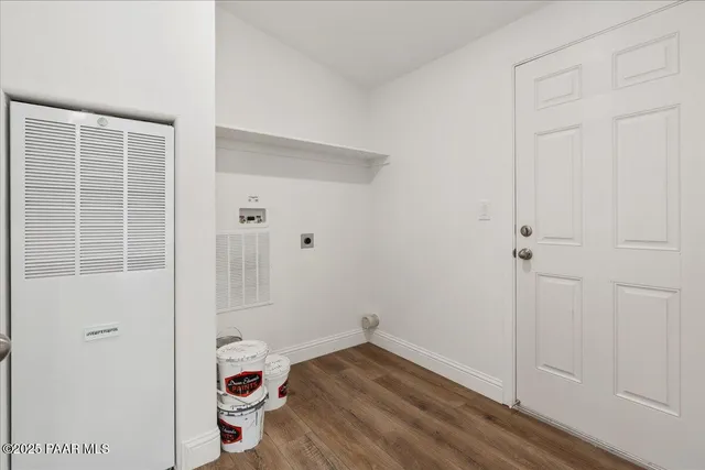 an empty room with a walk in closet and wooden floor