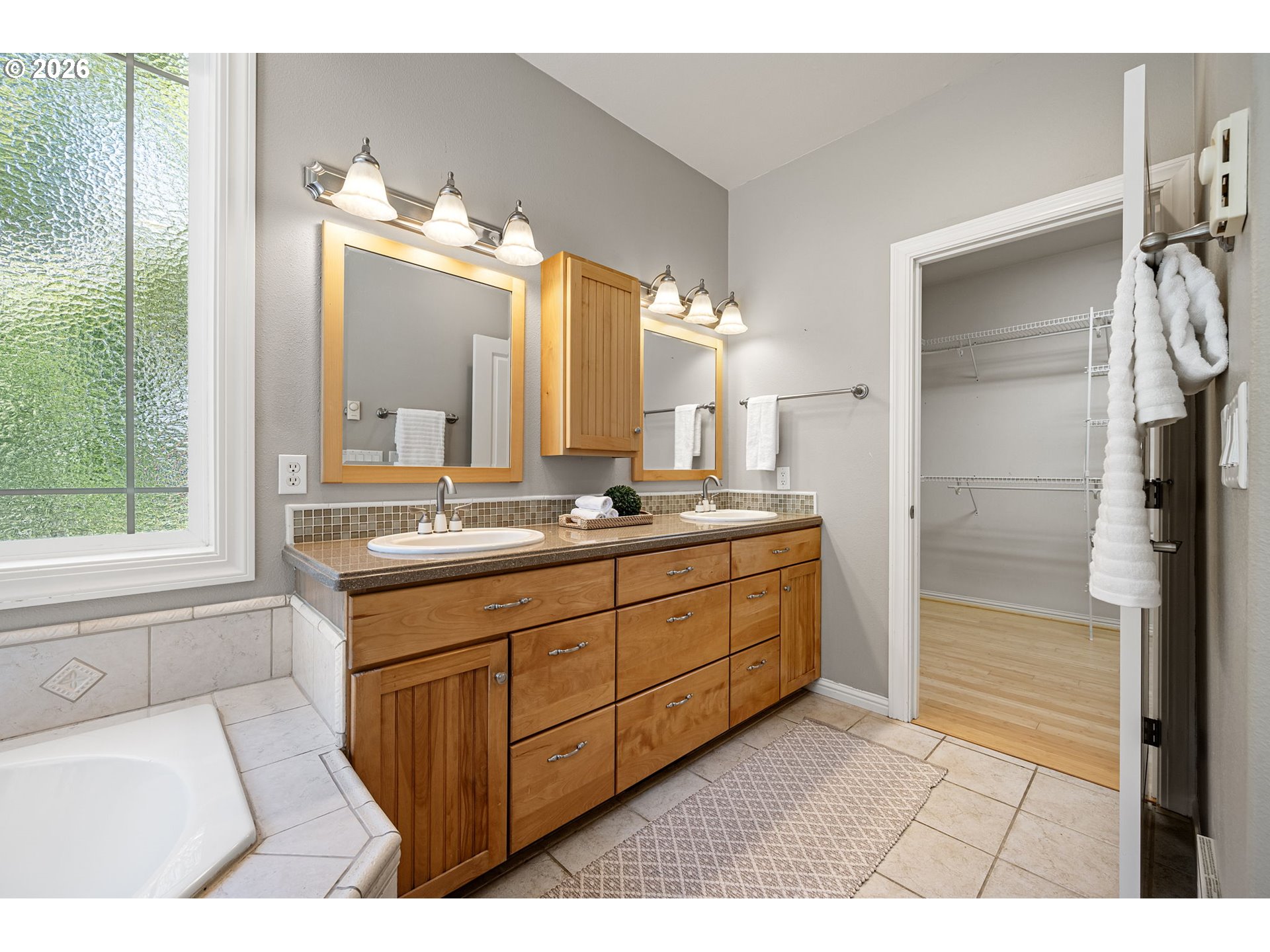 2218 Willow Loop Florence, OR 97439 - Photo 18 of 47 a bathroom with a double vanity sink a mirror and a shower