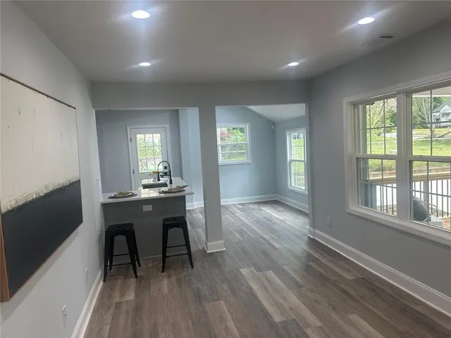 a view of a room with wooden floor and furniture