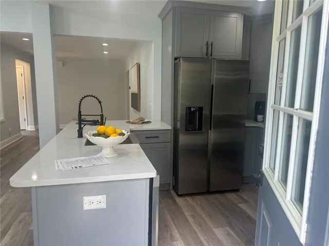 a kitchen with a refrigerator and a sink