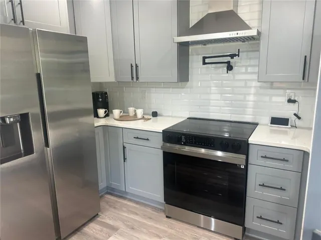 a kitchen with a stove sink and refrigerator