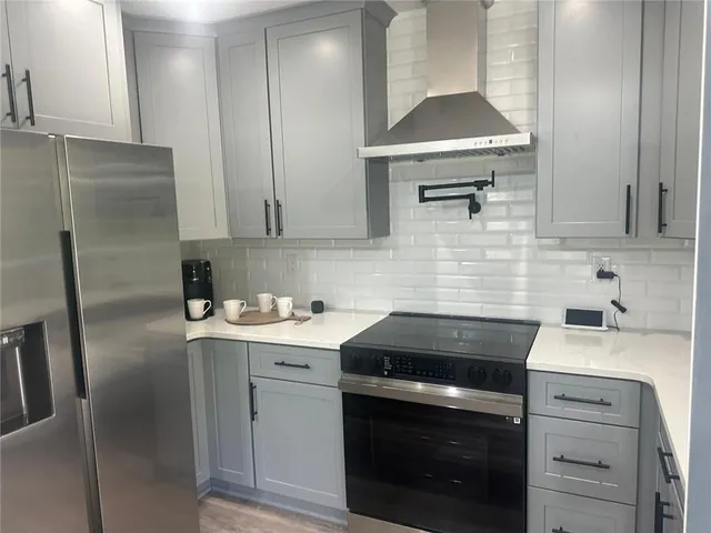 a kitchen with a sink stove and refrigerator