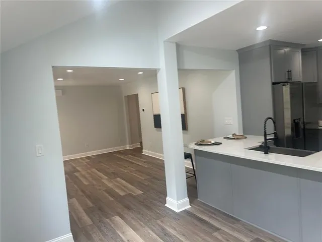 a view of a kitchen with wooden floor and staircase