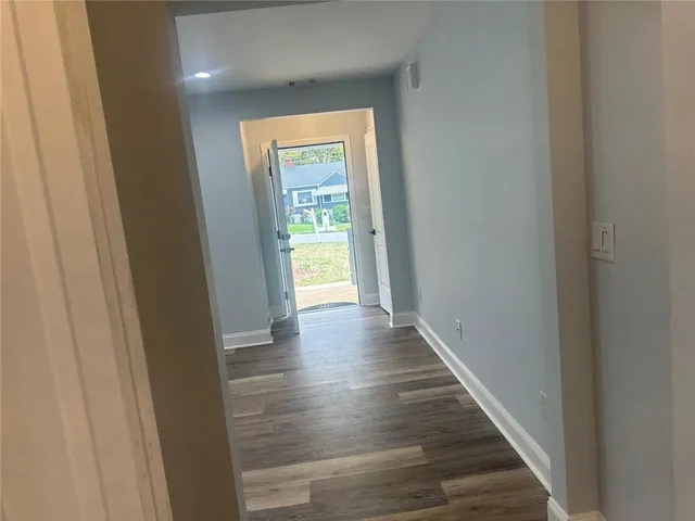 a view of a hallway with wooden floor