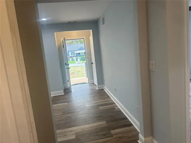 a view of a hallway with wooden floor and a hallway