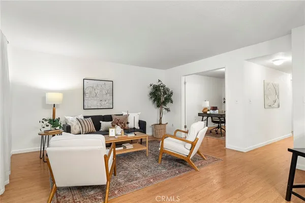 a living room with furniture and a potted plant