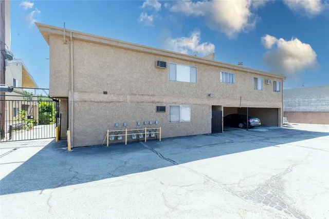 a view of a patio with table and chairs with wooden floor and fence