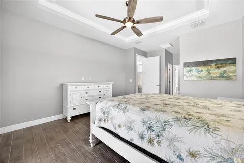 a bedroom with a bed and a chandelier