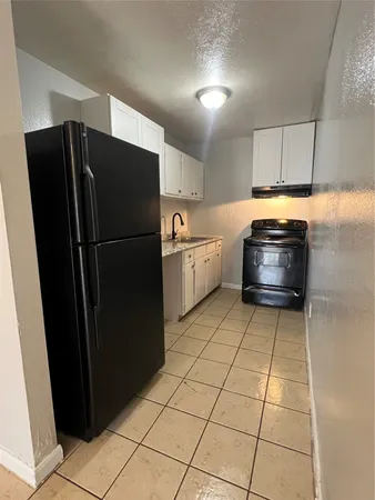 a kitchen with a refrigerator and a stove