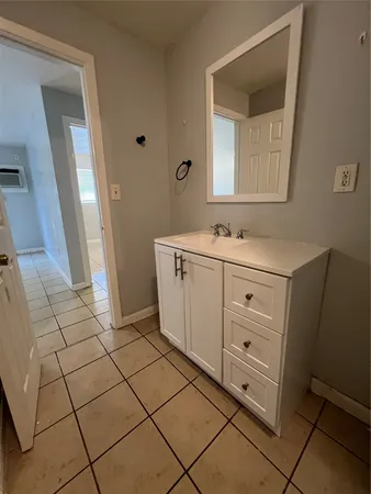 a room with a sink and a mirror