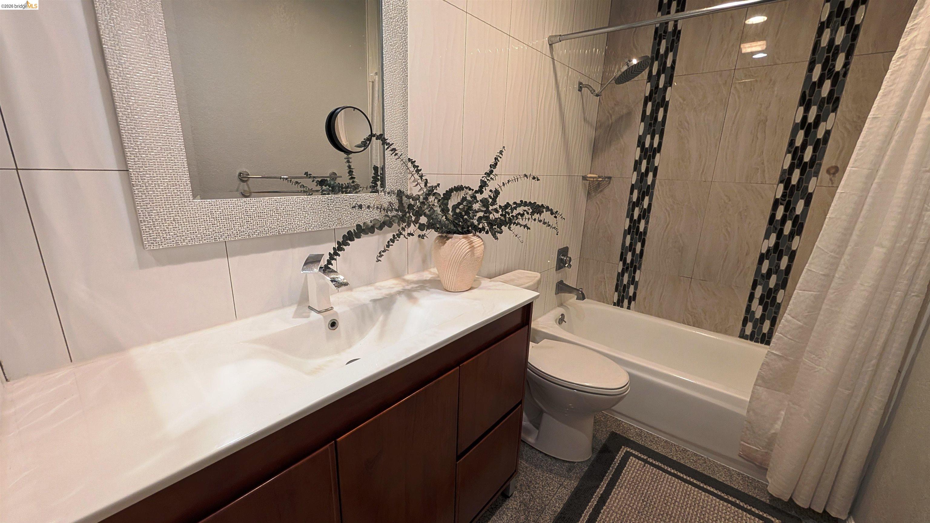 10013 Foxboro Circle San Ramon, CA 94583 - Photo 25 of 45 a bathroom with a sink a toilet a mirror and shower