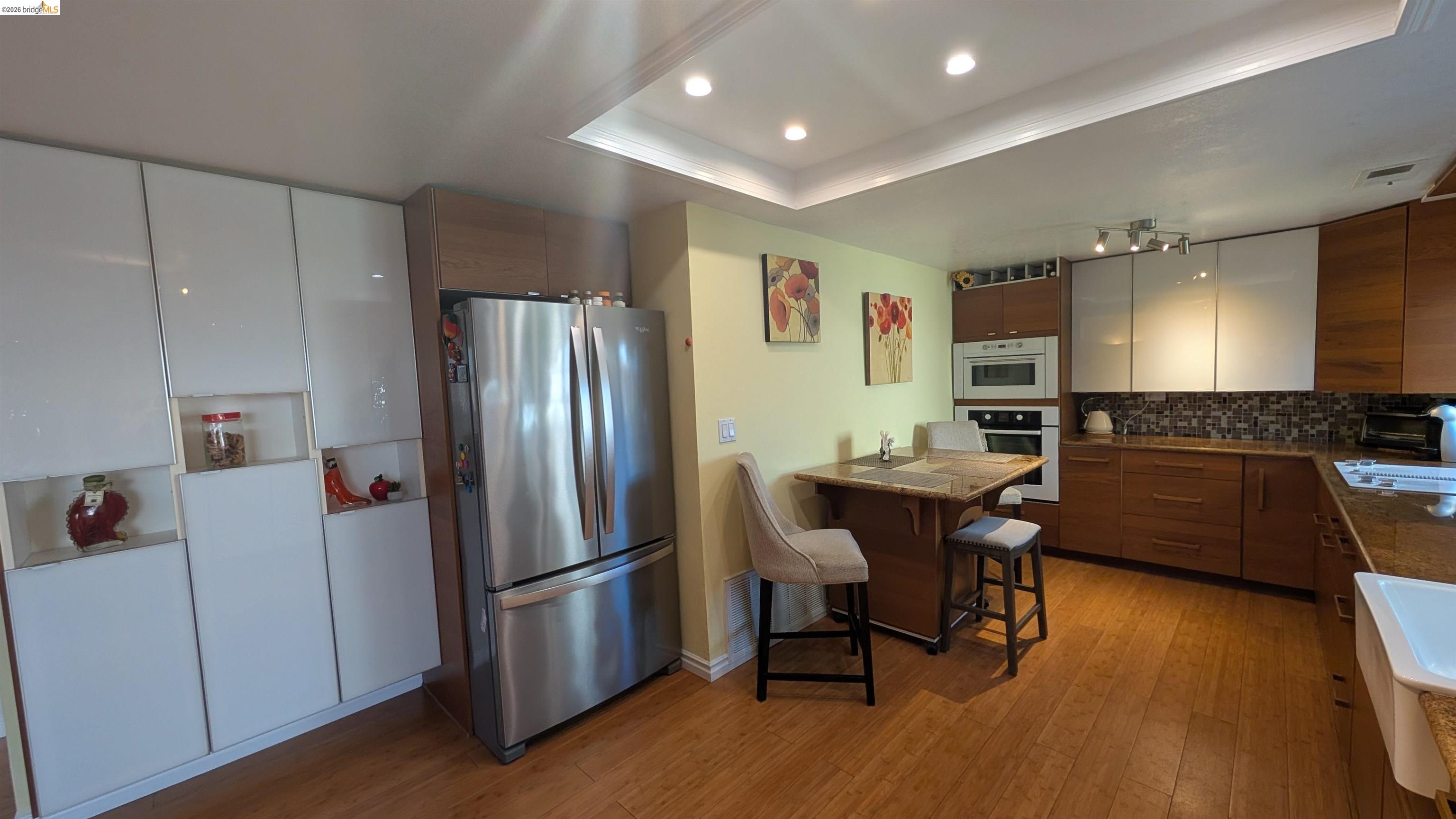 10013 Foxboro Circle San Ramon, CA 94583 - Photo 27 of 45 a kitchen with stainless steel appliances a refrigerator a sink a stove a dining table and chairs