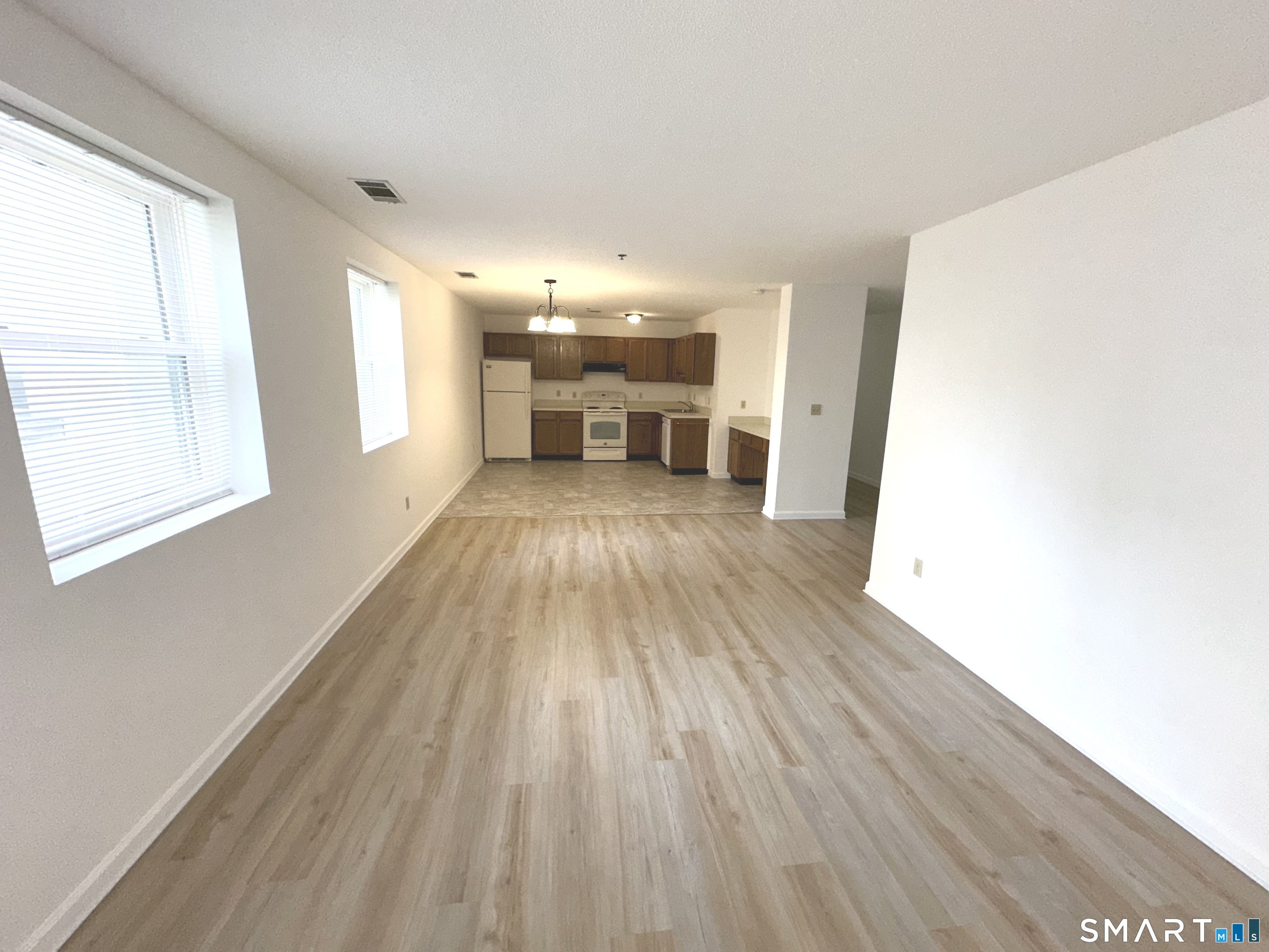 243 Judd Square, Unit 243 Wallingford, CT 06492 - Photo 7 of 17 a view of a livingroom with wooden floor